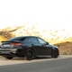 2023 mercedes-amg c 63 s e-performance in matte black photographed on the side of a mountain road in spain